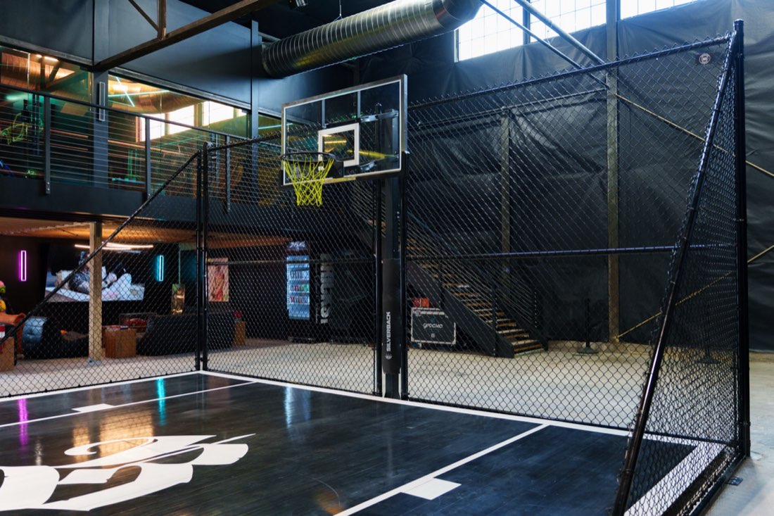 Black chain-link sport court enclosure around a backyard basketball court in Salt Lake City