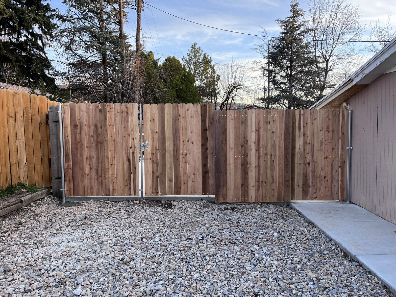 Cedar privacy fence and double gate in Bountiful, Utah, showing color variation from board to board