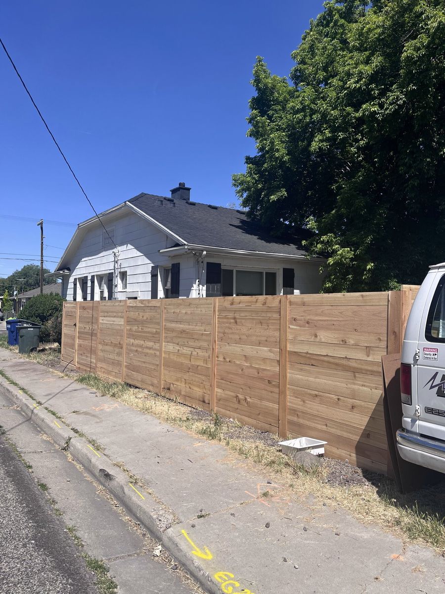 Horizontal board wood fence running along a sidewalk in Taylorsville, UT
